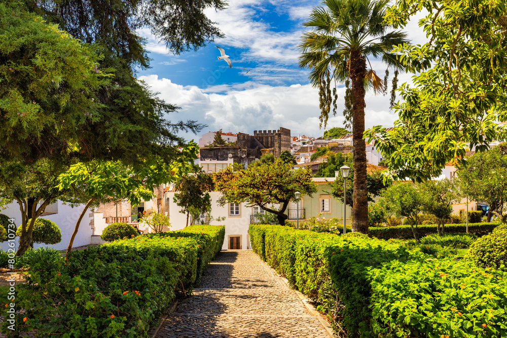 View of the city of Tavira, charming architecture of Tavira, Algarve, Portugal. Santiago of Tavira church in the old town of the beautiful city of Tavira in a sunny day. Algarve region, Portugal