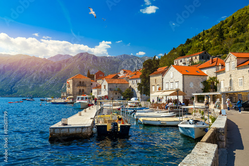 View of the historic town of Perast at famous Bay of Kotor on a beautiful sunny day with blue sky and clouds in summer, Montenegro. Historic city of Perast at Bay of Kotor in summer, Montenegro. photo
