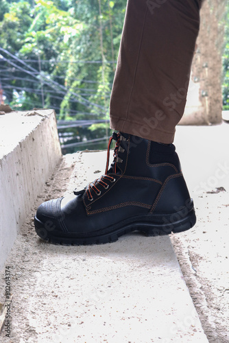 A construction worker wears brown leather boots which look very cool