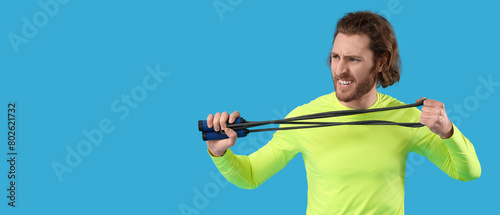 Sporty man with jumping rop...