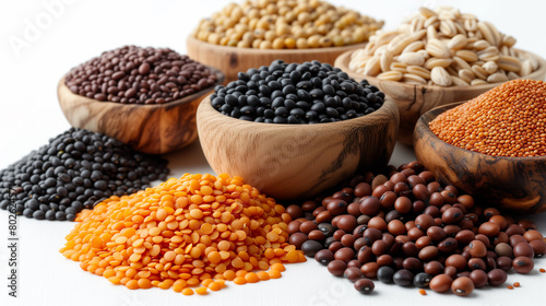 A diverse mix of legumes and cereals, including beans, peas, lentils, barley, and spelt, isolated on a white background.