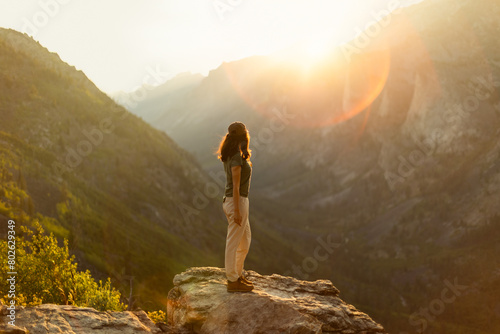 Woman hiker in the mountains at golden hour photo