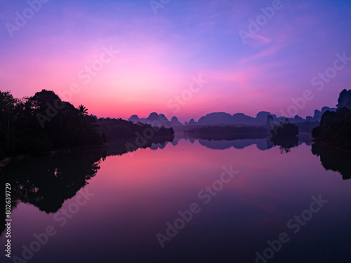 Aerial view Beautiful landscape nature view sunrise morning with reflections light over water surface during sunrise or sunset scenery mountains background © panya99