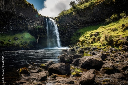 Majestic waterfall cascading through lush green landscape