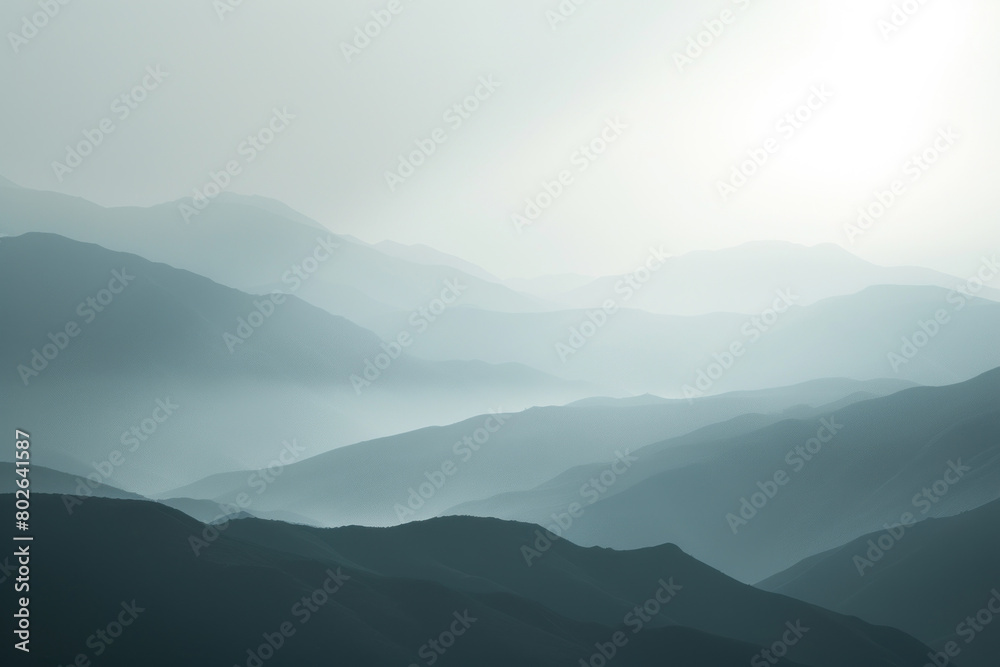 Soft Mist Overlapping Layers of Mountains in a Tranquil, Hazy Morning Light.
