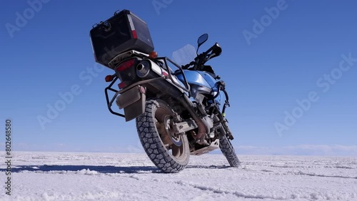 Low angle view of motorcycle parked on Uyuni Salt Flat lake, Bolivia photo