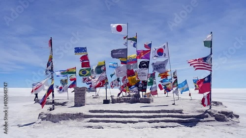 Plaza of flags fluttering in breeze on vast Uyuni Salt Flat, Bolivia photo