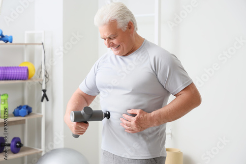 Sporty mature man massaging...