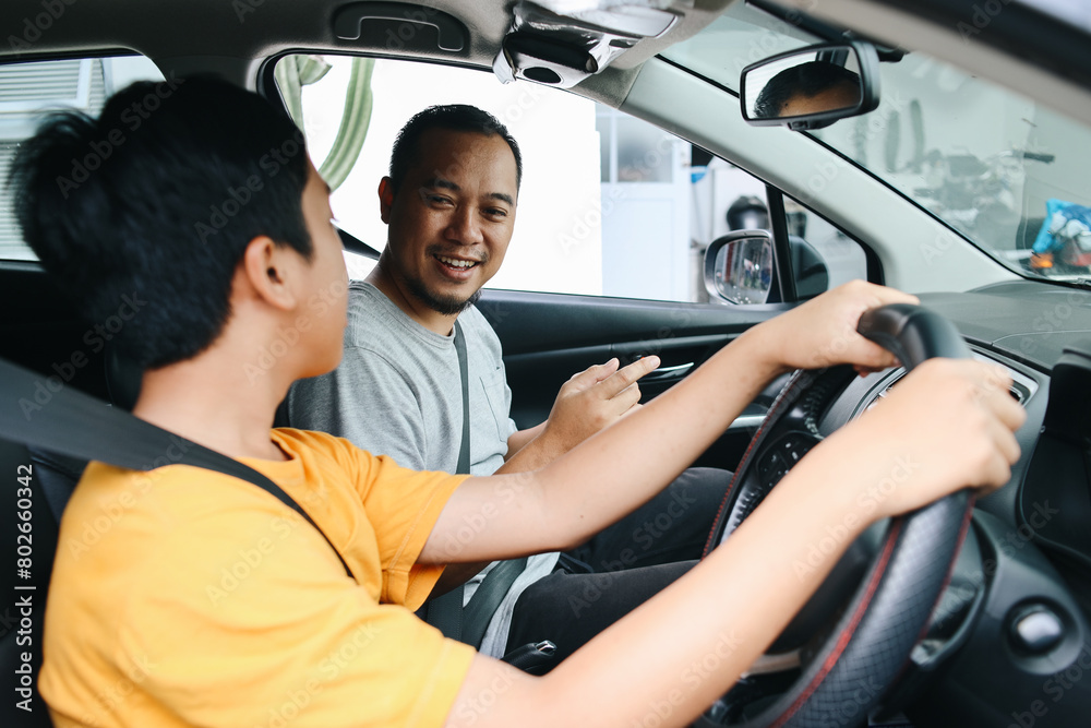 Father Teaching Teenager Son How to Drive A Car. Driving Course, Car Lesson. Father Teaching Teenager Son How to Drive A Car. Driving Course, Car Lesson.