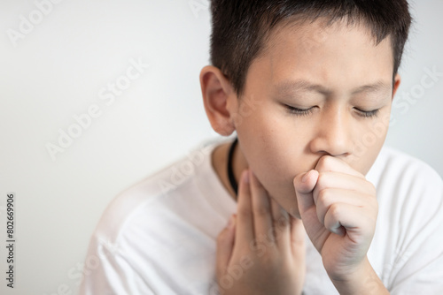 Tired child boy coughing and sore throat,a painful cough,pain in throat,lung inflammation, infection of bacterial or viral,Bronchial Pneumonia,disease of sickness, illness,health care,medical concept photo