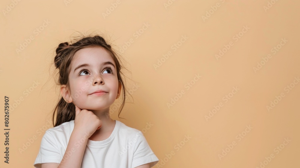 Dreamy Little Girl Imagining on Peach Background. Dreamy Little Girl Imagining on Peach Background.