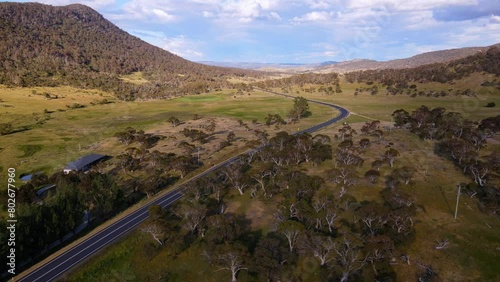 Drone view of country farm house and road with overcast sky in Crackenback, New South Wales, Australia photo