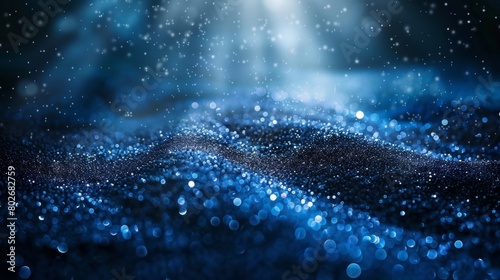 Beautiful serene landscape of sparkling blue particles with rays of light, creating a dreamy night sky effect.