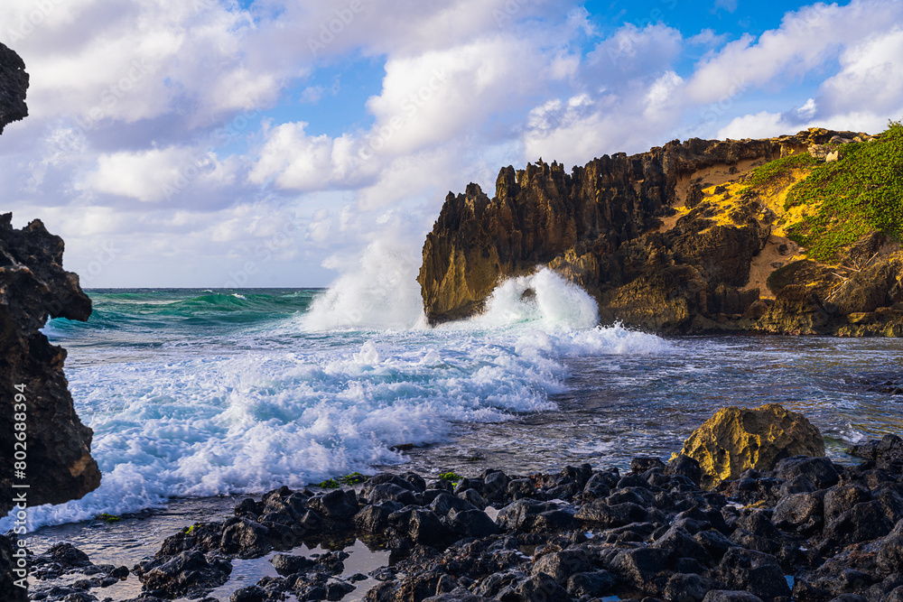 2023-12-31 ROCKY COASTLINE WITH WAVES CRASHING ON THE SHORE AND THE ROCK WALL WITH A NICE CLOUDY SKY ON KAUAI HAWAII