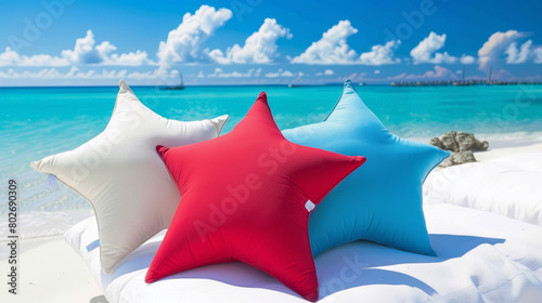 colorful starshaped pillows on beach with turquoise sea background photo