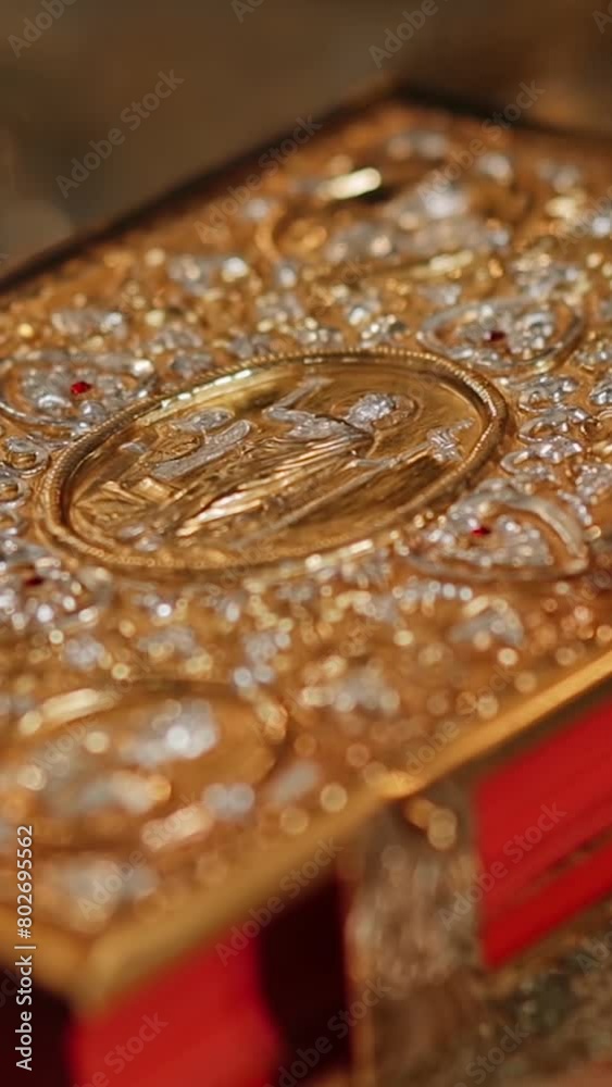 The holy book of the Bible in a golden binding on the throne in a church or temple. Greek catholic parish, Ukraine. Vertical video The holy book of the Bible in a golden binding on the throne in a church or temple. Greek catholic parish, Ukraine. Vertical video