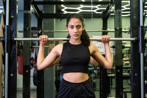 Fitness indian woman lifting t barbell in gym. sports Exercise, Workout, Weight Training, build muscle strength, health lifestyle. Challenge. Power. 