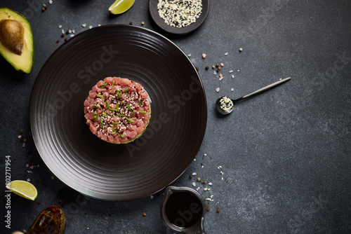 Tuna and avocado tartare on a dark ceramic plate © Anatoly Repin