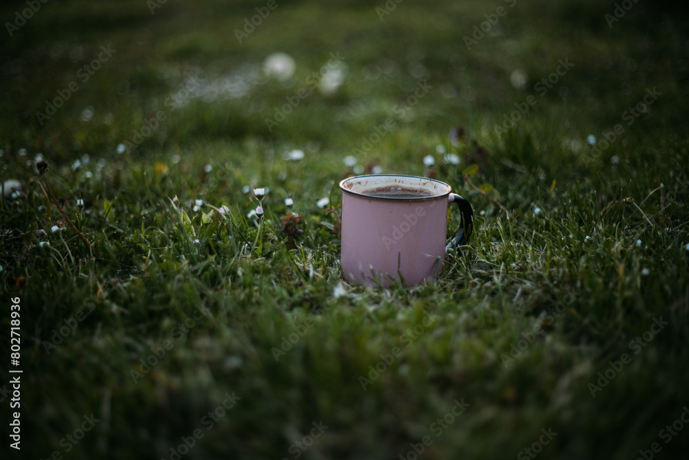 a cup of hot drink on a green lawn in the garden on a sunny day a cup of hot drink on a green lawn in the garden on a sunny day