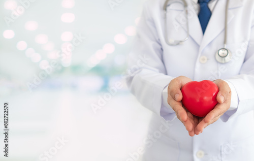 Cardiologist or Cardiac Surgeon doctor with heart on hand. .concept of heart healhcare checkup or health insurance. photo