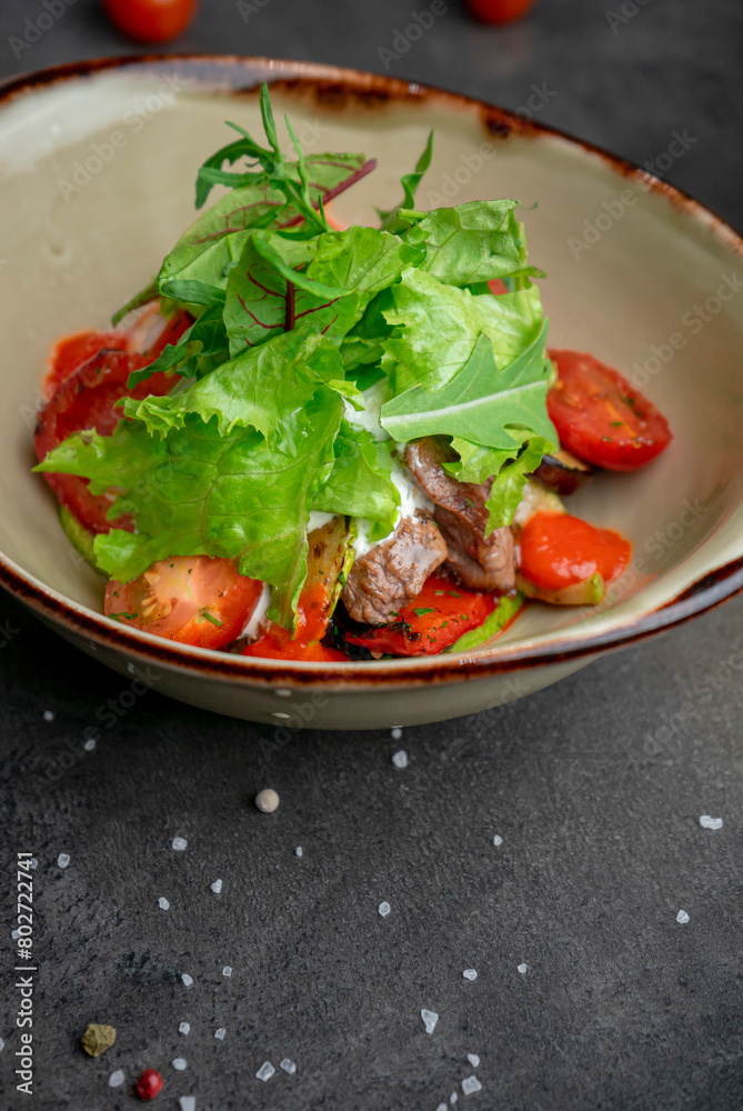 Warm salad with beef tender sauce and cherry tomatoes Warm salad with beef tender sauce and cherry tomatoes