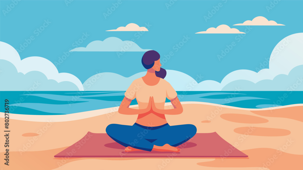 A person sitting on a beach towel hands resting gently on their knees and a content smile on their face as they meditate to the sound of the ocean..