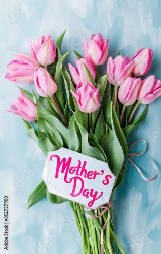 Tulips and words saying: Happy Mother's Day on blue background, Mother's Day greeting card, Happy Mother's Day