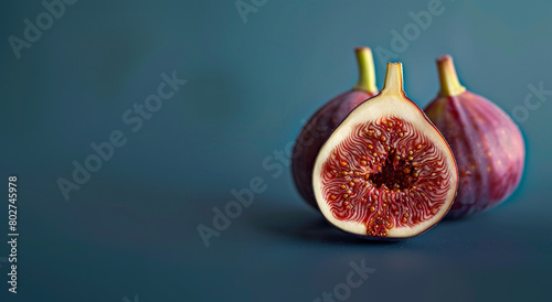 Ripe figs cut in half isolated on a neutral blue background. Aesthetic macro photo