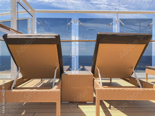 Deck chairs and sun loungers on outdoor swimmingpool pool deck with panoramic ocean views on modern luxury Italian cruiseship cruise ship liner photo