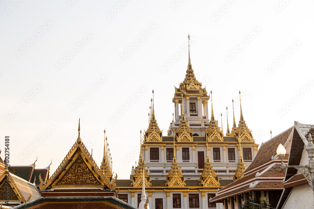 Fototapeta premium golden spires on top of buddhist thai temple in bangkok