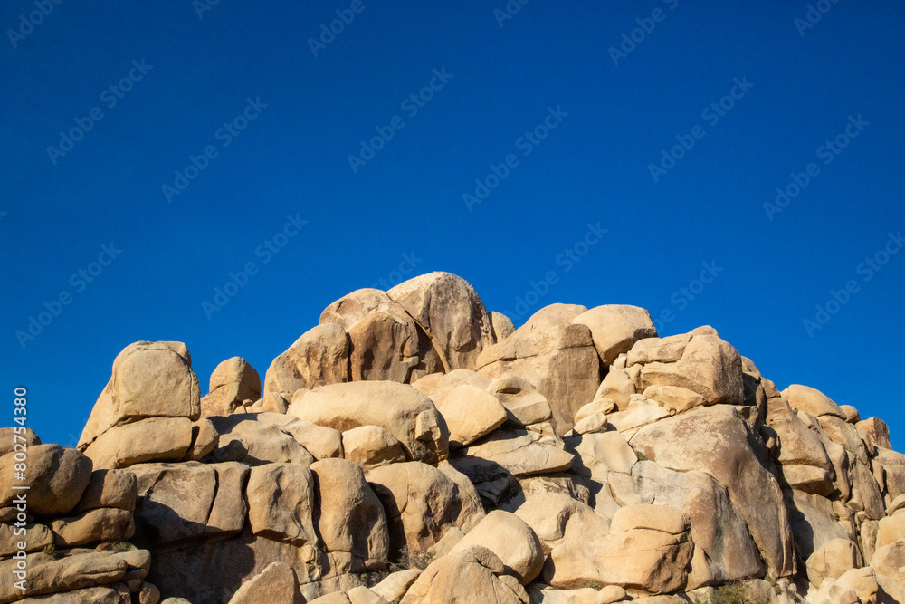 Joshua Tree's rugged rocks against an endless blue sky Joshua Tree's rugged rocks against an endless blue sky