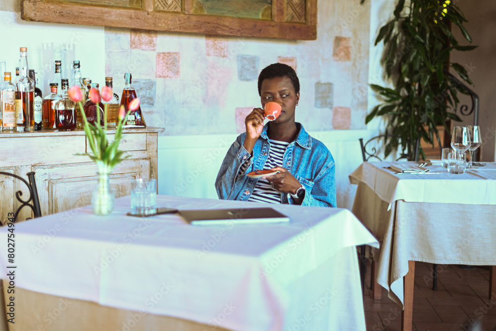 young short haired african woman have espresso coffee young short haired african woman have espresso coffee
