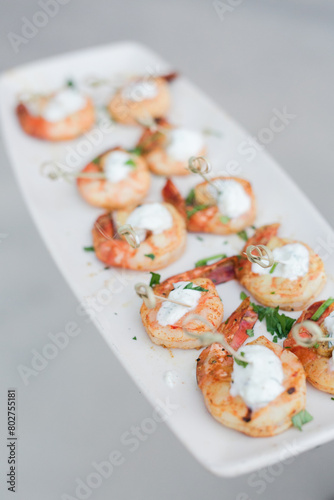 Grilled shrimp skewers with herbs and cream sauce