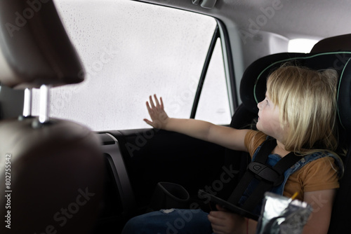 Young child fascinated by car wash from car seat © Cavan