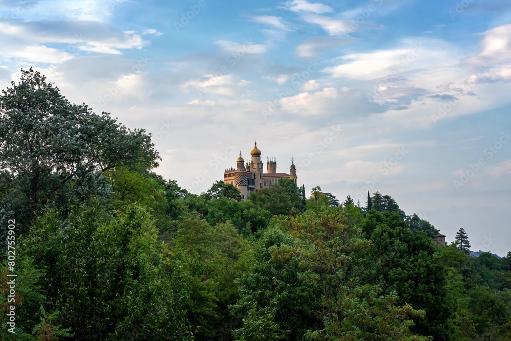 Rocchetta Mattei colorful fortress view behind the forest in Italy