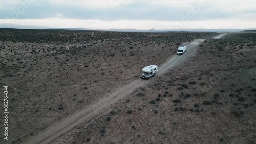 Amidst the desolate terrain near Salt Lake City, Utah, USA, camper trucks roam freely, embodying the essence of van life: a boundless pursuit of freedom, exploration, and adventure. photo