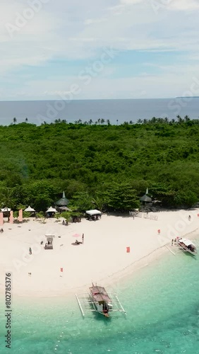 Sandy beach on a tropical island with palm trees. Virgin Island, Philippines.