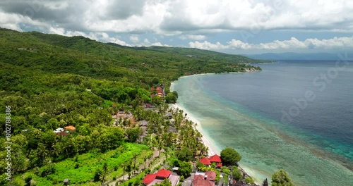 Tropical Nature With Thatched Houses In Coastal Town Resort In Northern Nusa Penida, Bali Indonesia. Aerial Drone Shot photo
