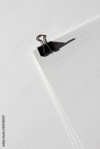 Blank Sheets of Paper Binded by Foldback Clip. Business Meeting Concept.