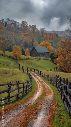 A farm in rural Rockbridge County, Buena Vista, Virginia, with a fence and a foggy fall day, as well as a dirt road driveway on a hill photo