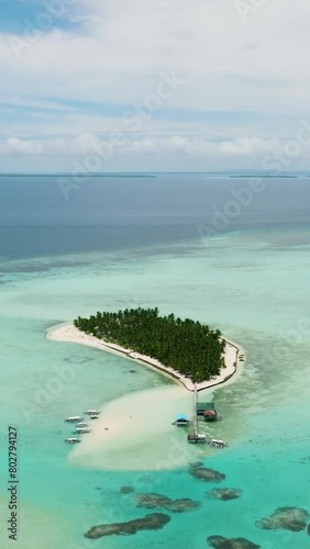 Island in the blue sea with a coral reef and the beach iew from above. Onok Island, Balabac, Philippines. photo