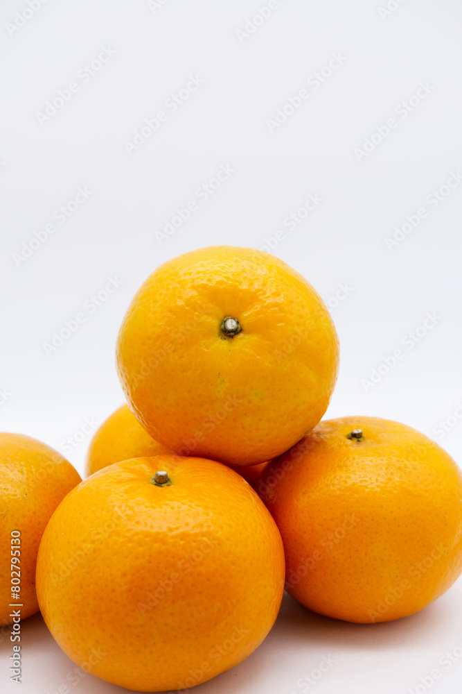 Mandarin oranges stacked together with a white background. Tangerine orange of healthy, organic and fresh fruit. Close-up fresh orange fruit texture with copy space. Still-life fruit with copy space. Mandarin oranges stacked together with a white background. Tangerine orange of healthy, organic and fresh fruit. Close-up fresh orange fruit texture with copy space. Still-life fruit with copy space.