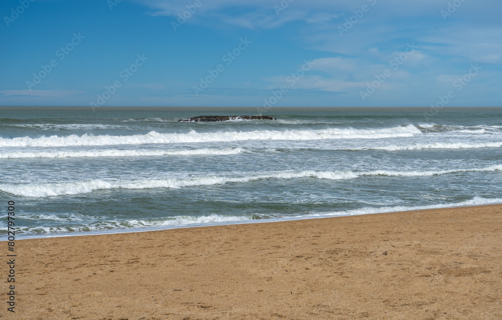 Sea Waves on Sandy Beach Texture Background, Transparent Ocean Water, Blue Sky, Sunny Shore Sea Waves on Sandy Beach Texture Background, Transparent Ocean Water, Blue Sky, Sunny Shore