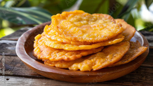 Authentic jamaican festival, a sweet, crispy cornmeal dumpling, traditionally served as a side, arranged on a wooden plate with tropical background photo