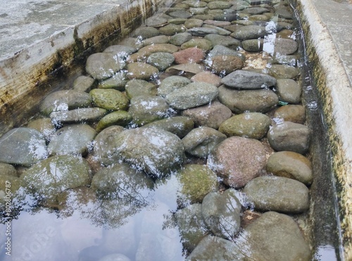 photo of stones soaked on the edge of the pool to decorate the swimming pool