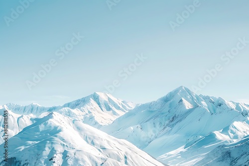 A snow-covered mountain range under a clear blue sky.
