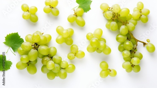 Green grapes and half sliced isolated on white background. Top view. Flat lay. Grape pattern texture background.