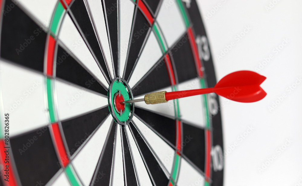 Business marketing success concept. The red dart arrow bullseye in the middle of the dart paper is the goal of the business. Business marketing success concept. The red dart arrow bullseye in the middle of the dart paper is the goal of the business.