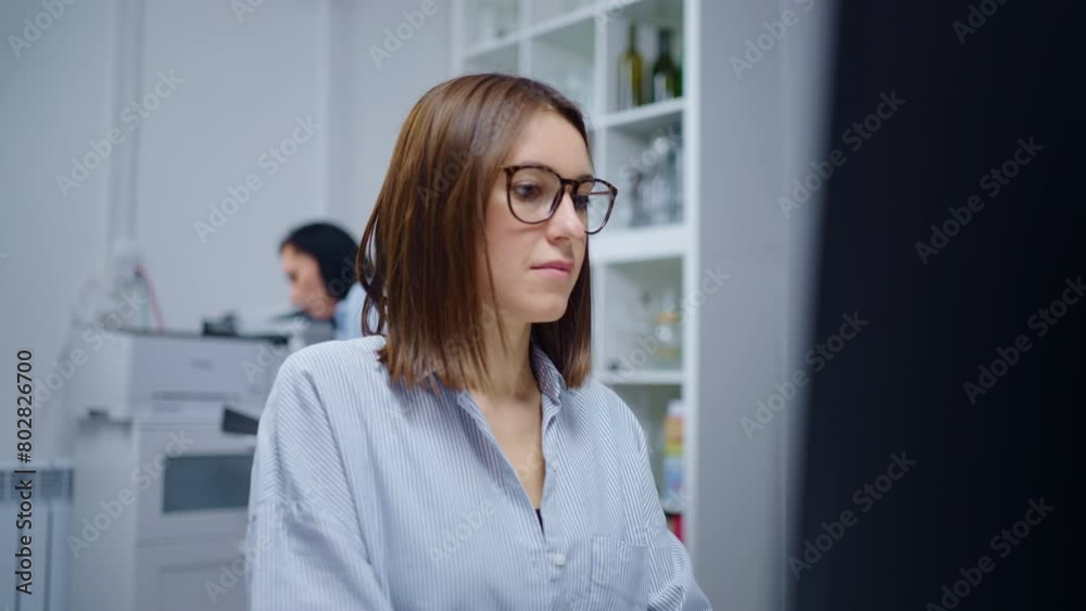 Portrait Of Young Smart Woman With Eyeglasses Working With Computer In Office, Medium Shot