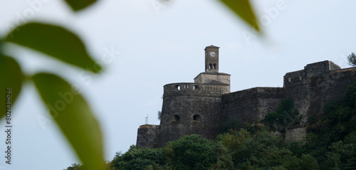 Fortress in Gjirokastra a huge stone building on a high mountain in Albania with a clock the history of the Middle Ages a beautiful view from the stone city to the ancient village photo